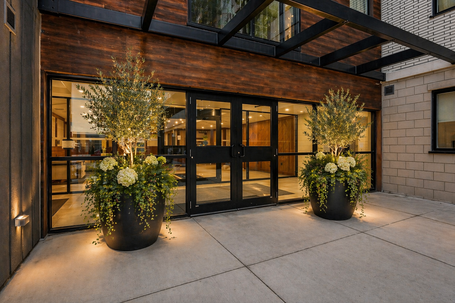 Marbella Condominiums entrance – courtyard with olive trees and hydrangeas at dusk, Niagara Falls
